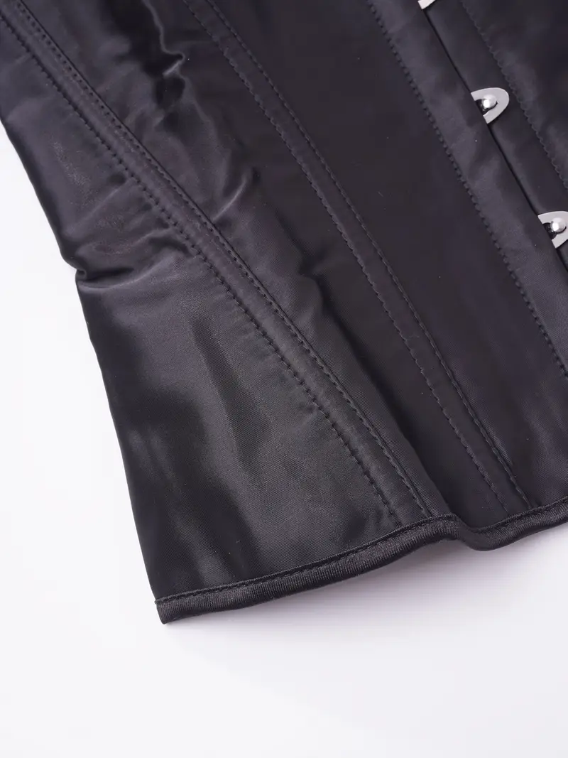 materiał oraz metalowe zapinki czarnego elastycznego gorsetu