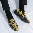 mężczyzna noszący złoto-czarne buty vintage męskie do eleganckich czarnych spodni