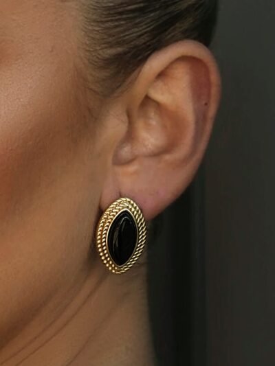 złoto-czarne kolczyki vintage na uchu modelki