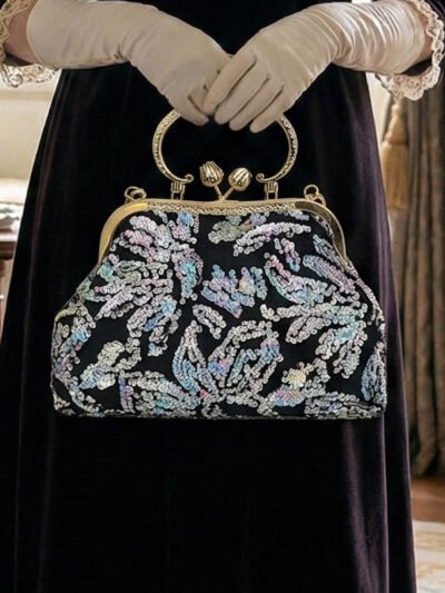 kobieta nosząca długą czarną elegancką sukienką oraz trzymająca torebkę vintage z cekinami